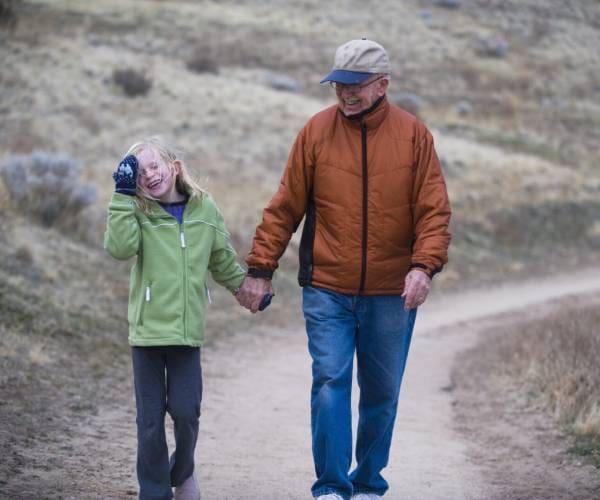 A man and child walking down the road